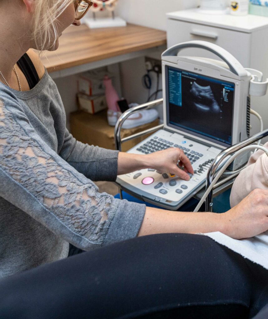 Physiotherapist using ultrasound to assess pelvic floor